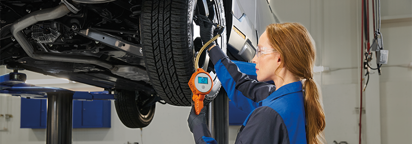A Subaru technician checking tire pressure. | Romeo Subaru in Saratoga Springs NY